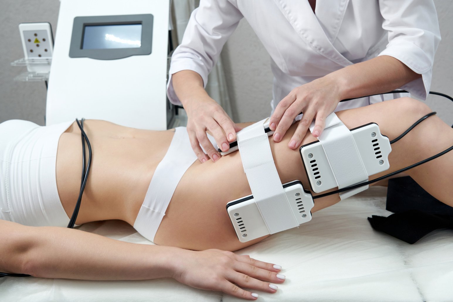 Beautiful Woman Getting Electro Stimulation . Laser Lipo Equipment. Cosmetic Fat Reduce Treatment. anti Cellulite Procedure